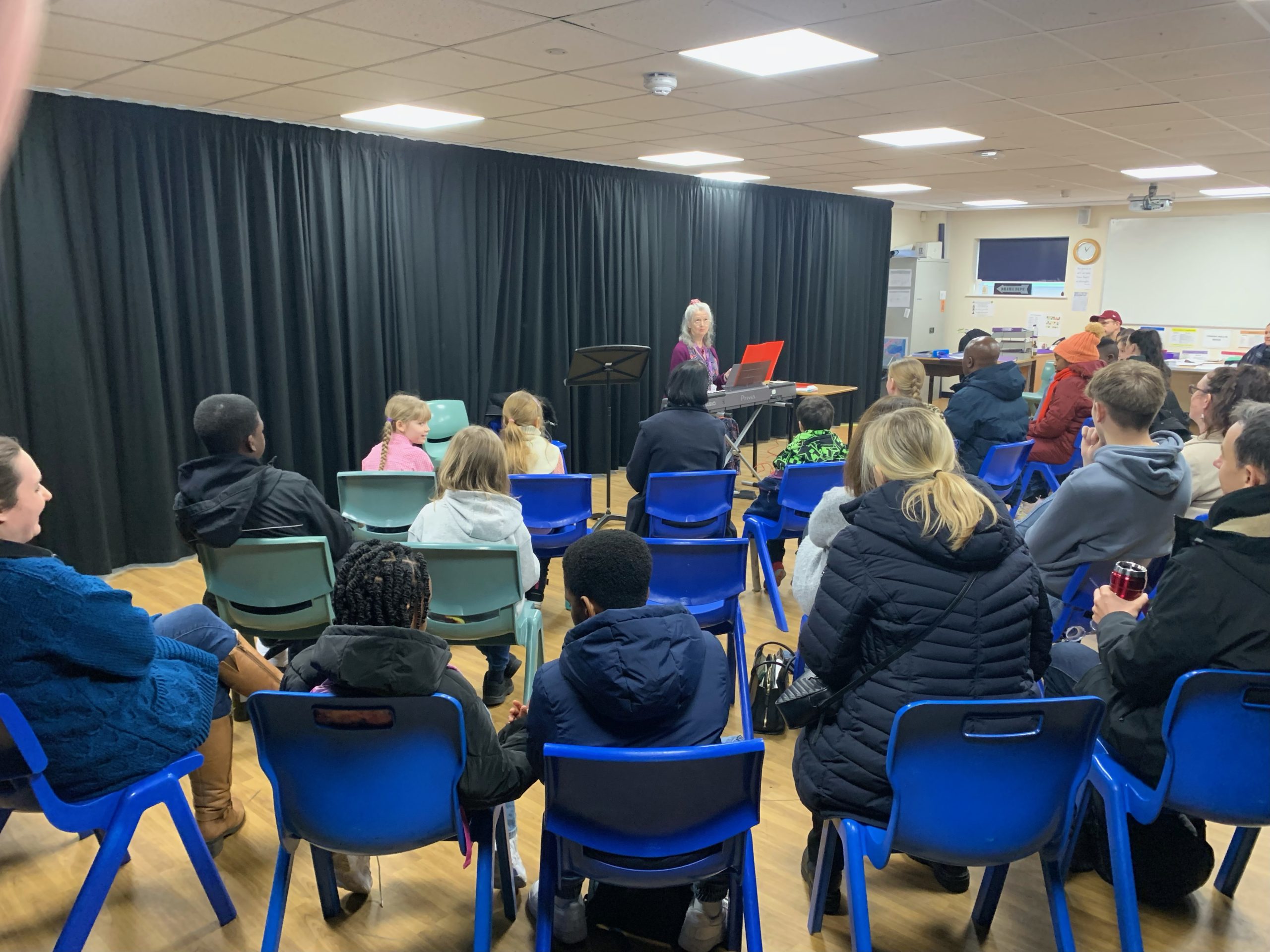 Attendees sat in a circle around expert Nancy Litten who is delivering a masterclass workshop on what examiners look for in music performances